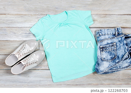 T-shirt mockup on wooden background. Perfect for displaying t-shirt designs. 122268703