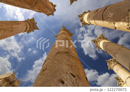 Roman Columns in the Jordanian city of Jerash (Gerasa of Antiquity), capital and largest city of Jerash Governorate, Jordan. Against the background of a beautiful sky with clouds Roman Columns in the Jordanian city of Jerash (Gerasa of Antiquity), capital and largest city of Jerash Governorate, Jordan. Against the background of a beautiful sky with clouds 122270072