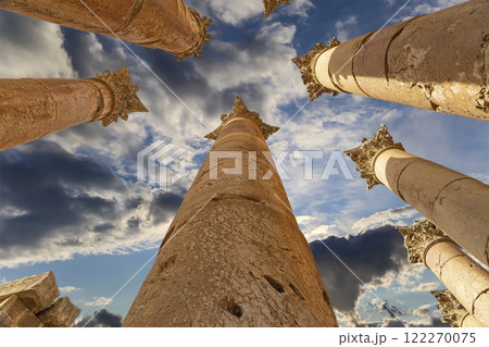 Roman Columns in the Jordanian city of Jerash (Gerasa of Antiquity), capital and largest city of Jerash Governorate, Jordan. Against the background of a beautiful sky with clouds 122270075