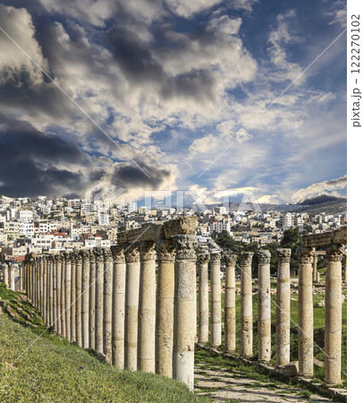 Roman Columns in the Jordanian city of Jerash (Gerasa of Antiquity), capital and largest city of Jerash Governorate, Jordan. Against the background of a beautiful sky with clouds 122270102