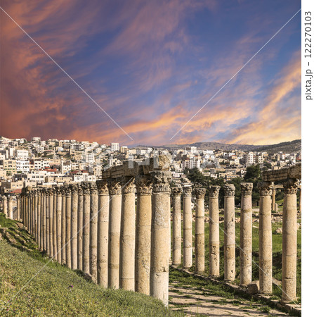 Roman Columns in the Jordanian city of Jerash (Gerasa of Antiquity), capital and largest city of Jerash Governorate, Jordan. Against the background of a beautiful sky with clouds 122270103