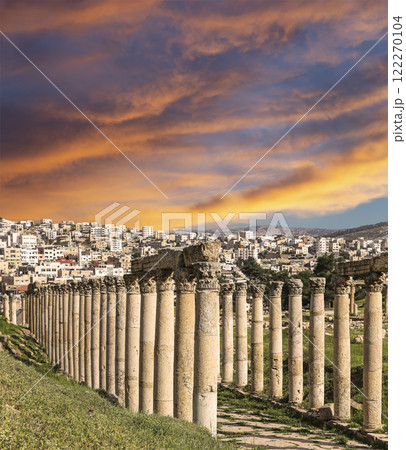 Roman Columns in the Jordanian city of Jerash (Gerasa of Antiquity), capital and largest city of Jerash Governorate, Jordan. Against the background of a beautiful sky with clouds 122270104