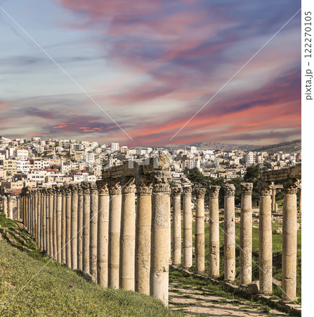 Roman Columns in the Jordanian city of Jerash (Gerasa of Antiquity), capital and largest city of Jerash Governorate, Jordan. Against the background of a beautiful sky with clouds 122270105