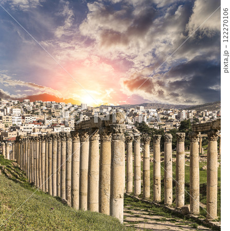 Roman Columns in the Jordanian city of Jerash (Gerasa of Antiquity), capital and largest city of Jerash Governorate, Jordan. Against the background of a beautiful sky with clouds 122270106