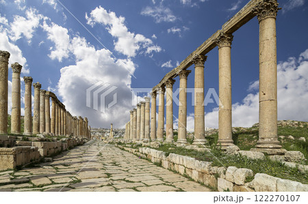 Roman Columns in the Jordanian city of Jerash (Gerasa of Antiquity), capital and largest city of Jerash Governorate, Jordan. Against the background of a beautiful sky with clouds 122270107