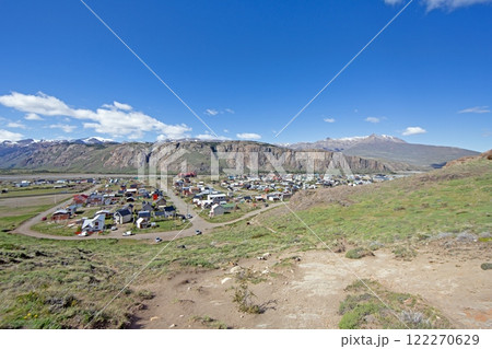 View of El Chalten village surrounded by rocky cliffs and snowy mountain peaks in Patagonia View of El Chalten village surrounded by rocky cliffs and snowy mountain peaks in Patagonia 122270629