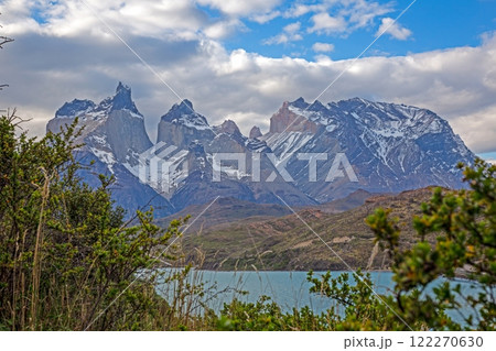 Panoramic view of Lake Pehoe with reflections of dramatic mountains and expansive skies in Torres del Paine 122270630