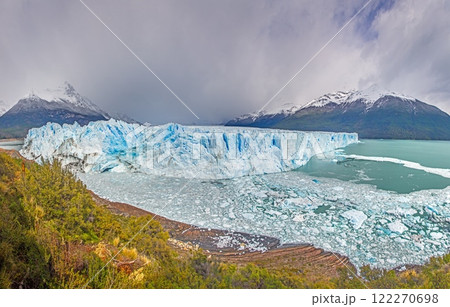 Perito Moreno Glacier with its dramatic icy wall and surrounding snowy mountains in Patagonia 122270698