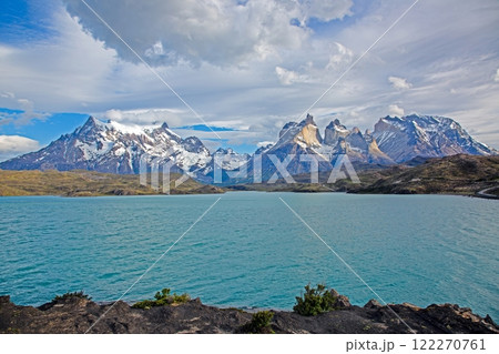 Panoramic view of Lake Pehoe with reflections of dramatic mountains and expansive skies in Torres del Paine Panoramic view of Lake Pehoe with reflections of dramatic mountains and expansive skies in Torres del Paine 122270761