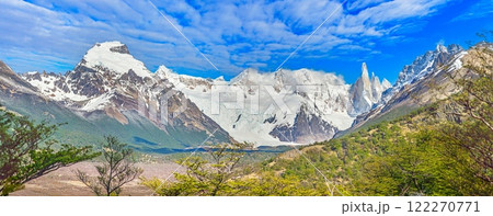 Panoramic view of Cerro Torre with lush foreground and dramatic snow capped mountains in Patagonia 122270771