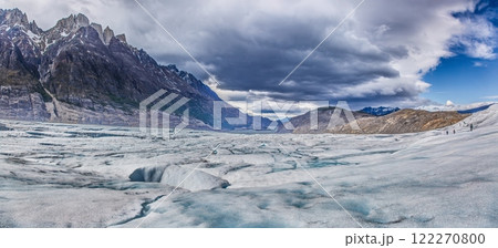 Surface of Grey Glacier with crevasses and surrounding dramatic mountains in Torres del Paine National Park 122270800