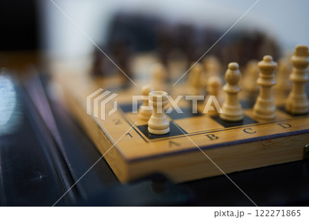 Chess pieces on board during a strategic match in a quiet room 122271865