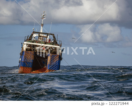 Large fishing vessel hauls trawling gear in the Atlantic waters. Large fishing vessel hauls trawling gear in the Atlantic waters. 122271944