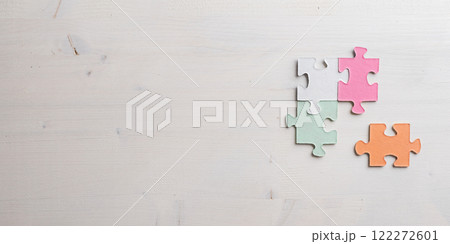 Three colorful blank puzzle pieces matched together with the fourth one next to them 122272601