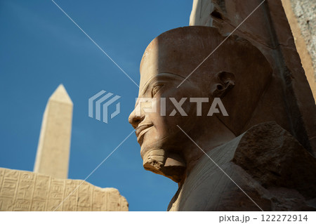 Statue of a pharaoh with an abelisk in the background in Luxor Statue of a pharaoh with an abelisk in the background in Luxor 122272914