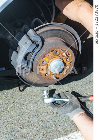 Car in service repairing. Detail of wheel assembly on automobile Car in service repairing. Detail of wheel assembly on automobile 122273970