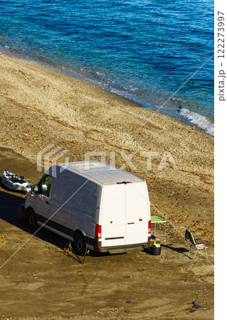 Van with camp equipment on beach. Aerial view 122273997