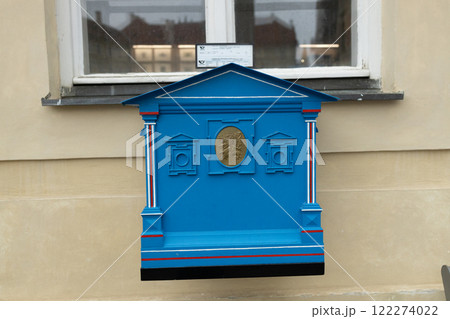 Vintage blue mailbox in front of the house wall (as blurred background). Close-up and selective focus. Vintage blue mailbox in front of the house wall (as blurred background). Close-up and selective focus. 122274022