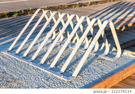 Metal parking lot for bicycles. Empty bicycle parking at city street 122274114