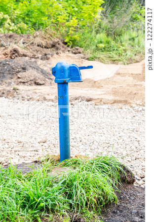 Old street free standpipe in summer. Point of withdrawal old metal water pump Old street free standpipe in summer. Point of withdrawal old metal water pump 122274117