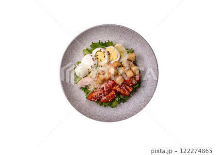 Delicious fresh salad with lettuce, croutons, chicken fillet, tomatoes and egg Delicious fresh salad with lettuce, croutons, chicken fillet, tomatoes and egg 122274865