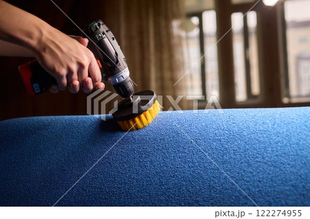 Using a power tool with a brush attachment can effectively clean upholstery furniture and fabrics Using a power tool with a brush attachment can effectively clean upholstery furniture and fabrics 122274955