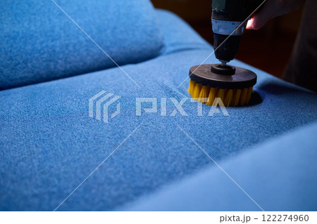 Using a power tool with a brush attachment can effectively clean upholstery furniture and fabrics Using a power tool with a brush attachment can effectively clean upholstery furniture and fabrics 122274960