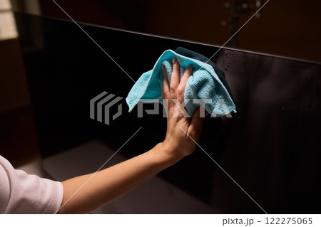 Effective and Safe Cleaning Techniques for a Curved Television Screen Using a Microfiber Cloth 122275065