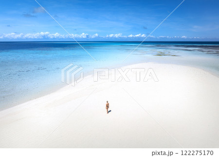 Aerial view of woman, sandbank, white sand, sea in low tide 122275170