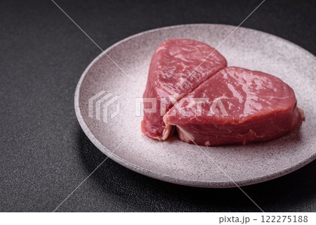 Ribeye steak raw with salt, spices and herbs Ribeye steak raw with salt, spices and herbs 122275188