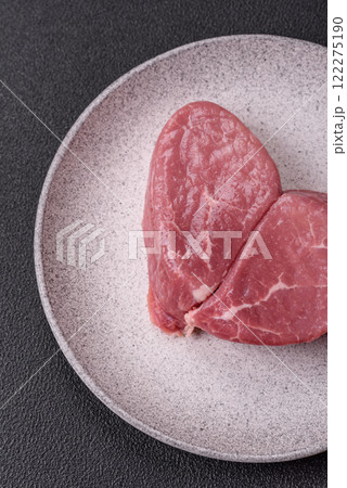 Ribeye steak raw with salt, spices and herbs 122275190