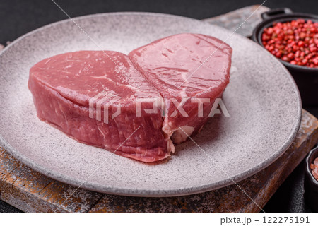 Ribeye steak raw with salt, spices and herbs 122275191