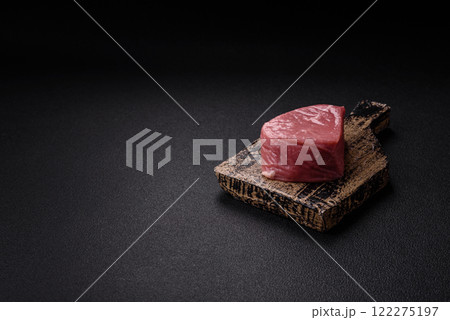 Ribeye steak raw with salt, spices and herbs Ribeye steak raw with salt, spices and herbs 122275197