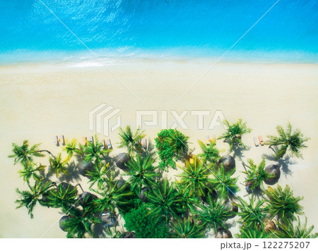 Aerial view of palms, umbrellas on empty sandy beach, blue sea Aerial view of palms, umbrellas on empty sandy beach, blue sea 122275207