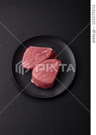 Ribeye steak raw with salt, spices and herbs 122275212