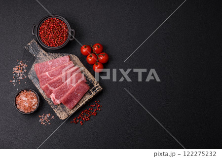 Juicy beef cut into slices with salt, spices and herbs 122275232