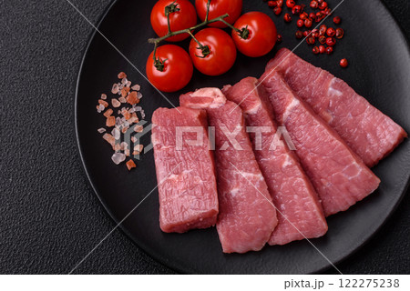 Juicy beef cut into slices with salt, spices and herbs 122275238