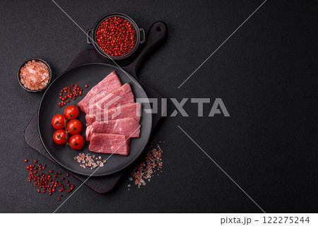 Juicy beef cut into slices with salt, spices and herbs 122275244