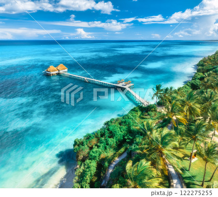 Aerial view of bungalow, white sandy beach, sea and palms 122275255