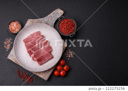 Juicy beef cut into slices with salt, spices and herbs Juicy beef cut into slices with salt, spices and herbs 122275256