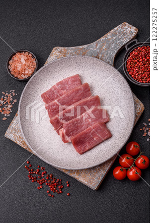 Juicy beef cut into slices with salt, spices and herbs Juicy beef cut into slices with salt, spices and herbs 122275257