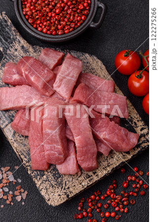 Juicy beef cut into slices with salt, spices and herbs 122275266