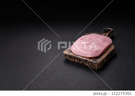 Ham, spam with salt, spices and herbs cut into slices Ham, spam with salt, spices and herbs cut into slices 122275302