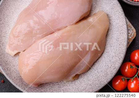 Pieces of raw chicken or turkey fillet with salt, spices and herbs Pieces of raw chicken or turkey fillet with salt, spices and herbs 122275540