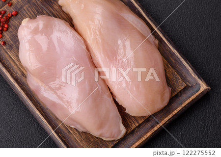 Pieces of raw chicken or turkey fillet with salt, spices and herbs 122275552