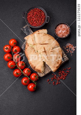 Round flatbread or pita with cheese, herbs, salt and spices Round flatbread or pita with cheese, herbs, salt and spices 122275639