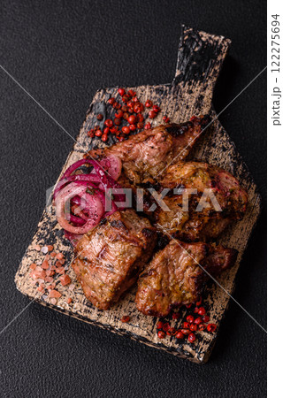 Pieces of beef meat cut into slices, marinated with salt and spices 122275694