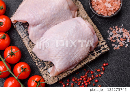 Raw chicken thighs with salt, spices and herbs 122275745