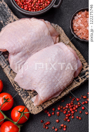 Raw chicken thighs with salt, spices and herbs 122275746