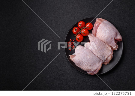Raw chicken thighs with salt, spices and herbs 122275751